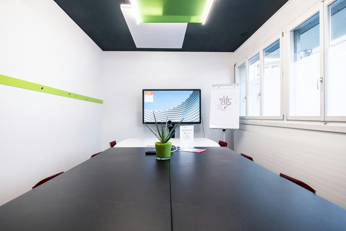 Modern meeting room with a wall-mounted screen