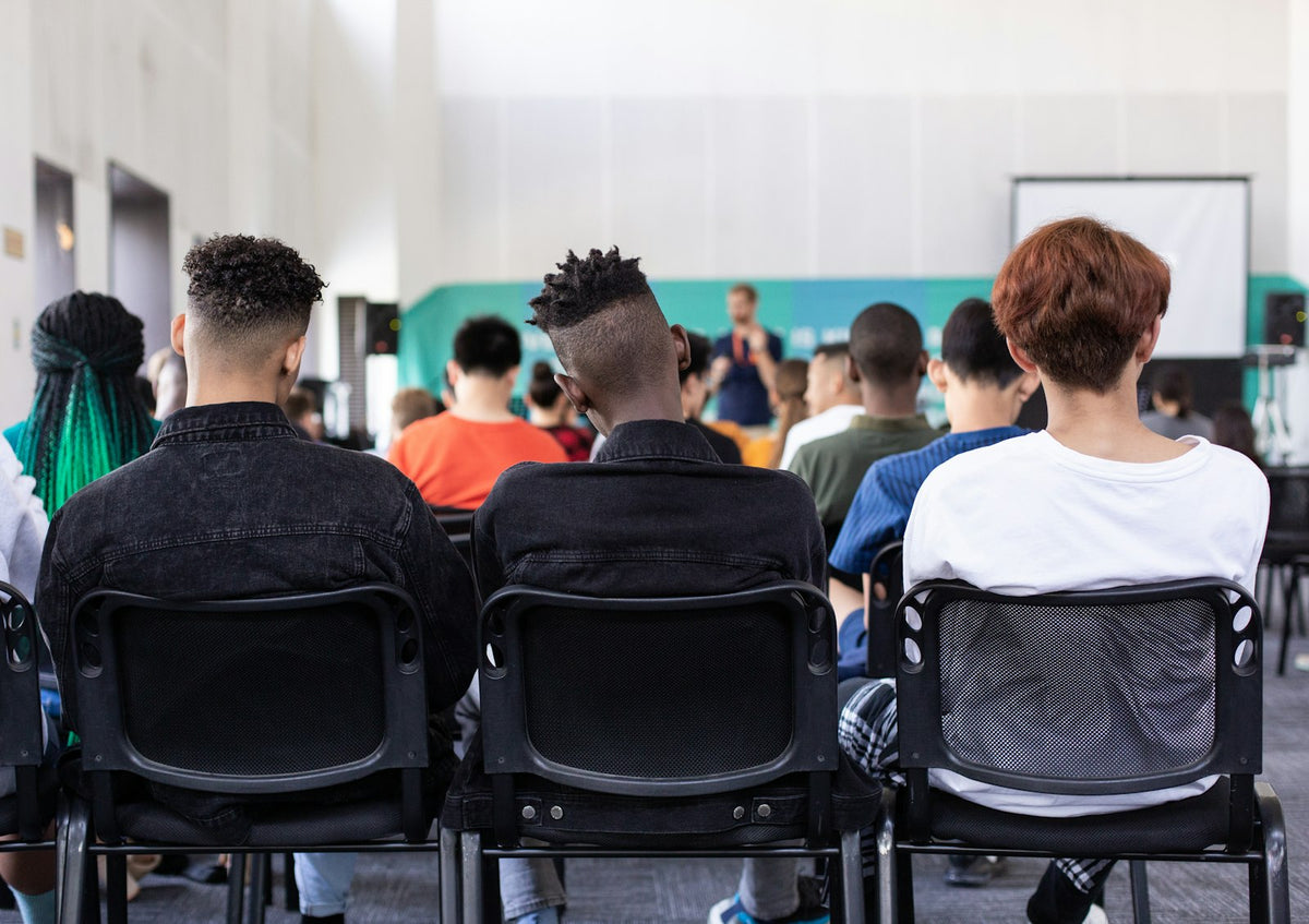 Secondary students seated facing the front of a room